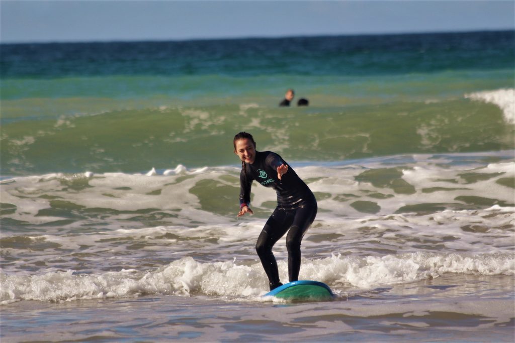 A girl riding a white water wave