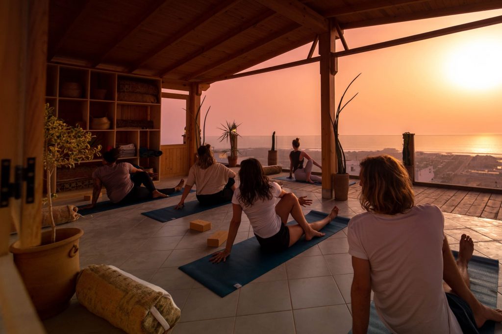 Yoga class at sunset on a rooftop