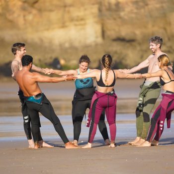 surfers stretching on the beach